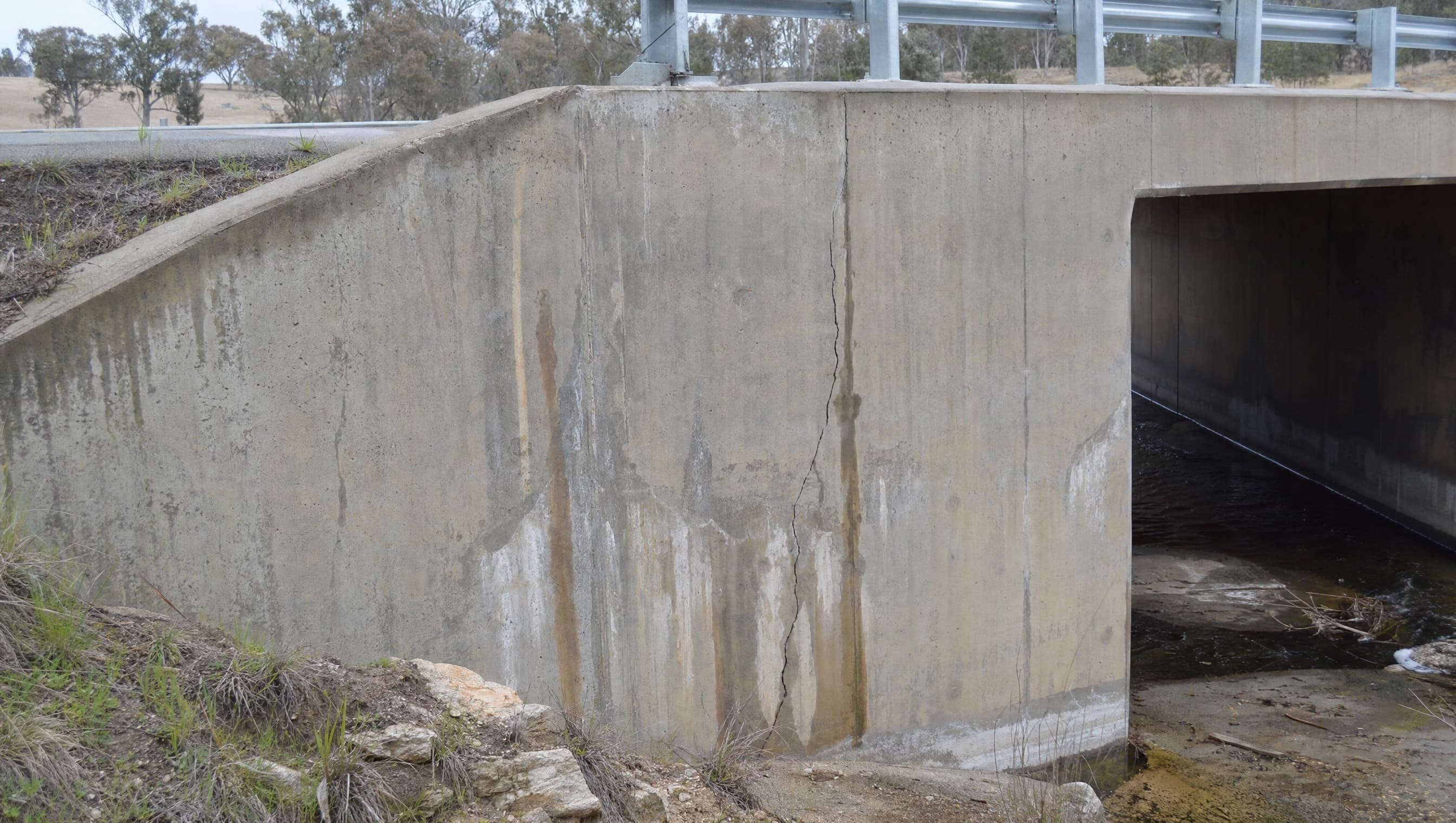 Concrete culvert wall and bridge underside used as a clean source frame for evidence review.