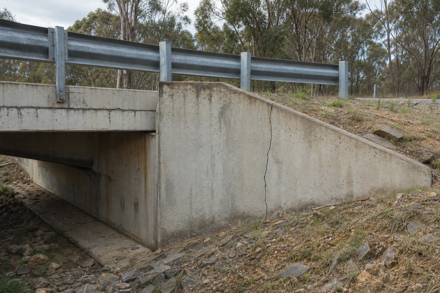 Concrete bridge and culvert structure with visible cracking.